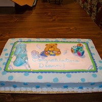 Baby Shower baby shower cake covered in bc icing. Booties and blocks made out of fondant. First attempt at making the booties