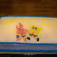 Spongebob 1St Birthday covered in buttercream icing. spongebob and patrick are gel transfers and filled in with icing.