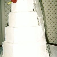 My 1St Wedding Cake All buttercream frosting. Getting the corners cut right was a bit difficult for me. the monogram on the bottom is not very clear here. I...