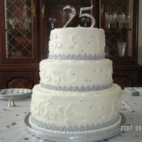 25Th Anniversary Cake This one got a little lop-sided in transport and I'm not super happy with the scroll work. I just can't for the life of me pipe...