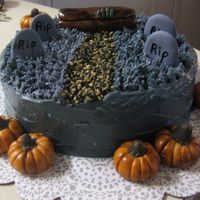 Graveyard Ok...Ok....its a little late but here is my halloween cake! Buttercream for the dead grass and the rest are gumpast figures. The walkway is...