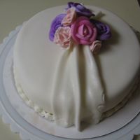 Pretty Simple This was made for a coworker of mine...Fondent covered cake w/ buttercream and gumpaste flowers. The small pink ones were supposed to be...