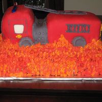 3D Fire Truck First attempt at a 3D fire truck. The truck it'self is two layers of carrot cale with cream cheese frosting on the inside. Truck...