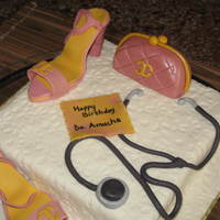 Hand Bag And Stetoscope light fruit cake, all decorations made with fondant