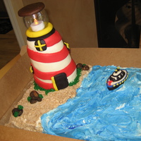 Lighthouse Cake lighthouse made from RKT, ocean and sand (made from crushed sugar cookies, sugar and brown sugar), boat made from fondant