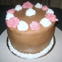 First Attempt At Flowers 4 layer hot cocoa cake filled with marshmallow buttercream, milk chocolate truffle and covered in chocolate buttercream. First attempt at...