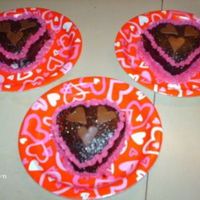 Mini Choc Hearts made these for my dd and her friends they are mini heart choc cakes with b/c filling and piping with choc ganache and tootsie roll hearts....