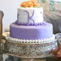 Purple Initial Cake This was a birthday cake for a friend. The cake is covered in fondant (MMF). The roses are also fondant as is the initial K.The little...
