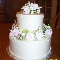 Pentecost Shower This is a 6" and 10" tiered cake covered in buttercream. The tiers are separated with columns to allow room for the flowers. The...