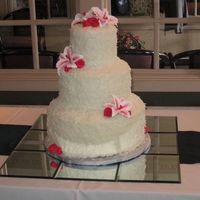 Coconut Covered Cake This was for my sister. All tiers were about 6" tall with the coconut. The bottom and top tiers are chocolate with cookies and cream...