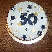 50Th Birthday This is a 10" round cake covered with buttercream. The black and gold decorations are made from fondant.