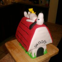 Snoopy Dog House Cake carved to resemble Snoopy's doghouse. Made for grandmother's 83rd birthday. All fondant accents. Snoopy laying on top of...