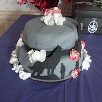 Twilight: New Moon Cake is covered in fondant marbelized to look like the moon. Some flowers are painted with red on the edges to match petals of flower on...