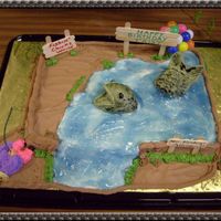 Catching The Big One Girl lying on "ground" with feet against cake trying to reel in over-sized fish! I used piping gel tinted with blue over white...