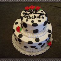 Polka Dot Fun White two tier buttercream with fondant black dots.