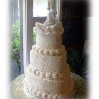 Lacey Hearts With Buttercream Roses Borders 3-tiered heart-shaped wedding cake with cornelli lace design & buttercream roses for borders.