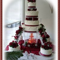 Lace And Roses 4 tier buttercream with 4 8" round satellite cakes done in cornelli lace.