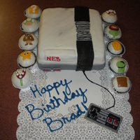 Nintendo Cake Nintendo square cake covered in MMF, cupcakes with MMF characters from Mario Brothers Game