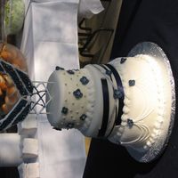 Savannah's Wedding Cake Airforce themed wedding, 10", 8", 6" cakes. Royal Icing topper of airforce symbol, royal icing flowers, ribbon, and...