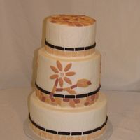 Flower Mosaic This buttercream cake has a mosaic of fondant pieces in earth tones.