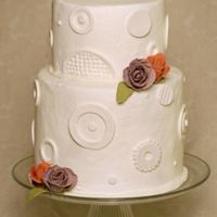 Modern Wedding Cake A buttercream with fondant circle pattern and gumpaste roses.
