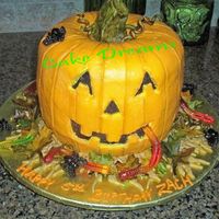 Halloween Birthday Jack-O-Lantern Chocolate cake with BC icing and fondant stem and leaves.Gummy worms and spiders.