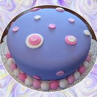 Polka Dot Birthday Cake Purple fondant covered cake with polka dots.