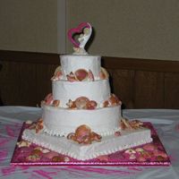 Beach Themed Wedding Cake I didn't make this cake, my husbands Grandmother did for our Wedding.It's covered in buttercream, gives it a nice "wave&quot...