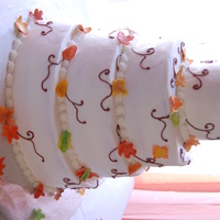 Fall Wedding Cakes were iced with buttercream icing, leaves were made of gumpaste and dusted with fall colors.
