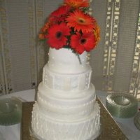 Img_1840.jpg MMF wedding cake. THe inside is orange buttercream and alternateing raspberry buttercream.