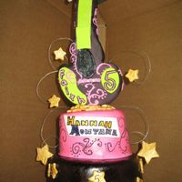 Hannah Montana This cake is filled with choc covered strawberry filling and then covered in MMF. The guitar is RKT and covered in MMF.
