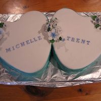 Michelle & Trent Engagement Cake These cakes were Chocolate Mud and Caramel Mud cakes, only the top of the cake is fondant with flowerpaste decorations. The sides are...