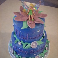 Tinkerbell This cake is covered in MMF and decorated with sugar paste flowers. The cake was for my niece, so I used a toy Tinkerbell, so she could...