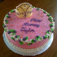 Fancy Nancy Round cake frosted in BC decorated to coordinate with the book character Fancy Nancy. The crown is made of white modeling chocolate and...