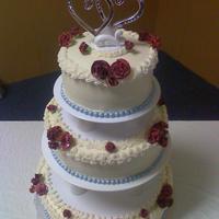 Betty's Cake Round BC covered cake decorated with silver sixlets for the border and burgandy gumpaste carnations