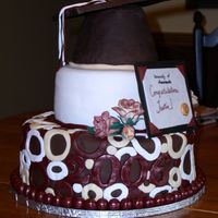 Umass Graduation Cake This was a cake for a UMASS gradutiaon party. The bottom tier is alternating vanilla sponge and chocolate cakes with chocolate buttercream...