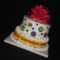 Festive Birthday Cake Simple tiered cake. The customer just asked for something colorful. Made the bow from fondant and painted it w/sugar glaze to make it shiny...