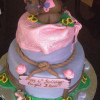 Cowgirl 6" and 9" round from CC inspiration cakes. My daughter made the horse--:) Fun cake!!