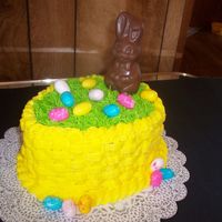 1St. Easter Cake Chocolate cake with lemon yellow basket weave. On top I have bubble gum easter eggs with a hollow chocolate bunny sitting on top of grass....