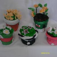 Candy Flower Pots these are candy flower pots. the pot is made of fondant and the flowers of gum paste.Inside of the flower is melted candy melts. and the...