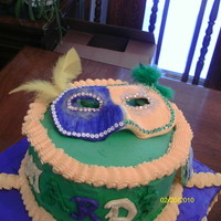Mardi Gras Cake gumpaste mask, coins,and beads buttercream icing.
