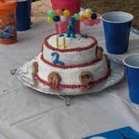 Small 2 Tier Cookie Monster small 2 tier, each 2 layers with bc and reeses candy mixed in icing.