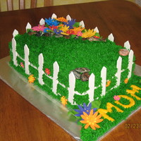 Picket Fence With Flowers This was for my moms b-day a couple years ago just now getting around to posting it. Grass is buttercream; fence, rocks and flowers are...