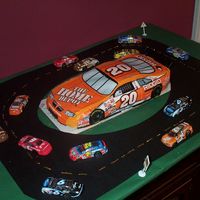 Nascar Cake NASCAR cake kit with chocolate NASCARs around cake.
