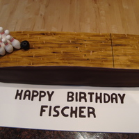 Bowling Alley Cake this was made with 8x8 pans cut in half and stacked. it was covered in chocolate fondant. the lane is fondant that was painted to look like...