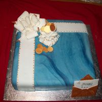 Parcel Cake This is a matured rum cake. The bow, the money bag and the envelope are made of gumpaste and all the gold accents are gold dust mixed with...
