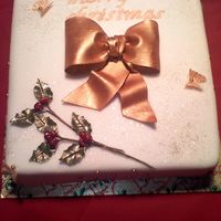 Christmas Cake This is my first christmas cake and the first of 6 this week (oh cr*p lol). The accents are all gumpaste including the holy and the gold is...