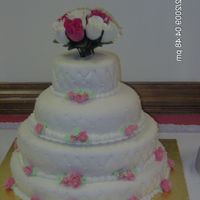 Biggest Cake this was a three tiered covered in buttercream and then fondant the quilt diamond pattern was done on the sides with edible pearls attached...