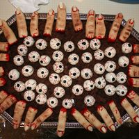 Fingers And Eyeballs Fingers made from NFSC with red piping gel for blood. Eyeballs are cake truffles dipped in white chocolate and painted with food coloring...