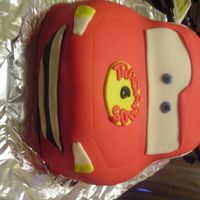 Lightning Mcqueen This cake was done for a birthday boy who loves cars! All cake carved and then topped with fondant. All decorations are fondant also.